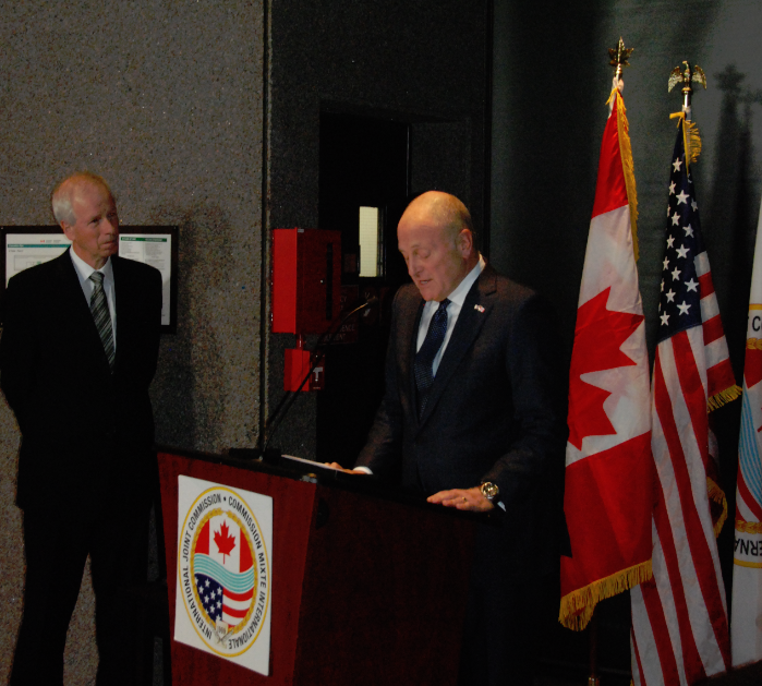 Heyman, at podium, speaks during IJC reception while Dion, at left, looks on. Credit: IJC files 